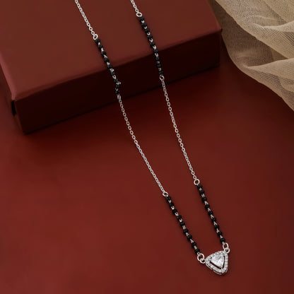 Necklace with a heart-shaped pendant on a red surface