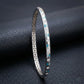 Silver bracelet with blue accents on a dark textured surface