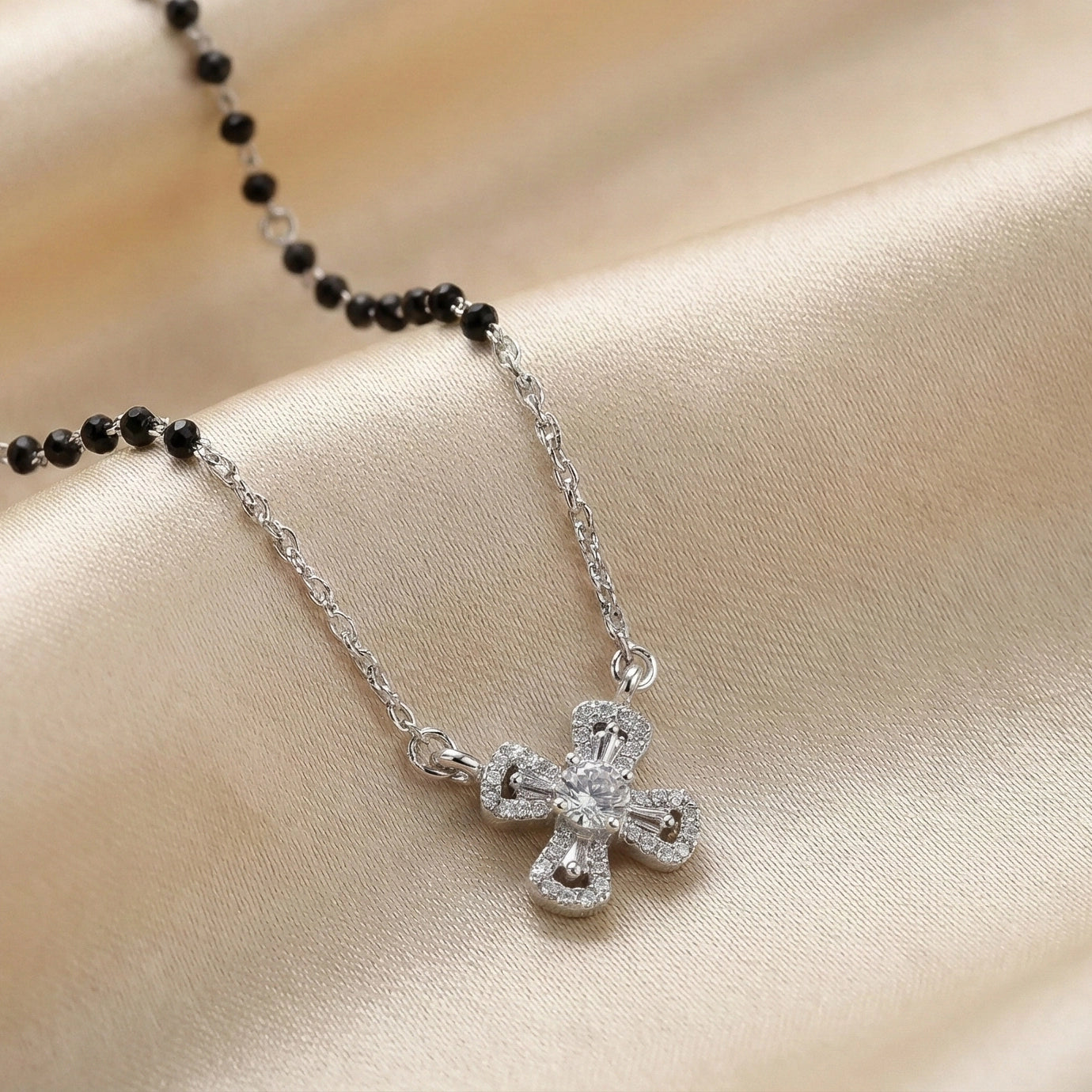 Modern silver mangalsutra featuring black beads and cross pendant