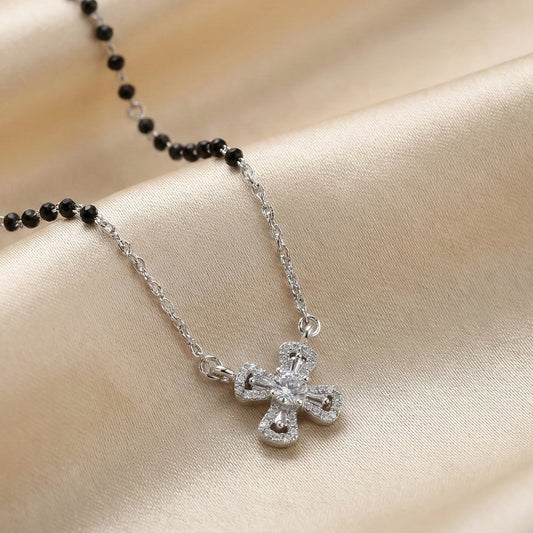 Modern silver mangalsutra featuring black beads and cross pendant