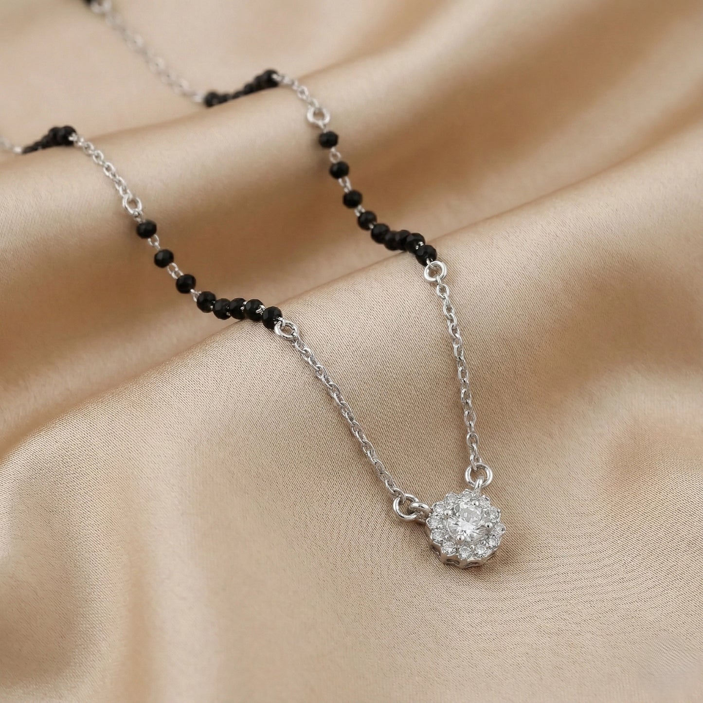 Silver mangalsutra with black beads and floral diamond cluster pendant