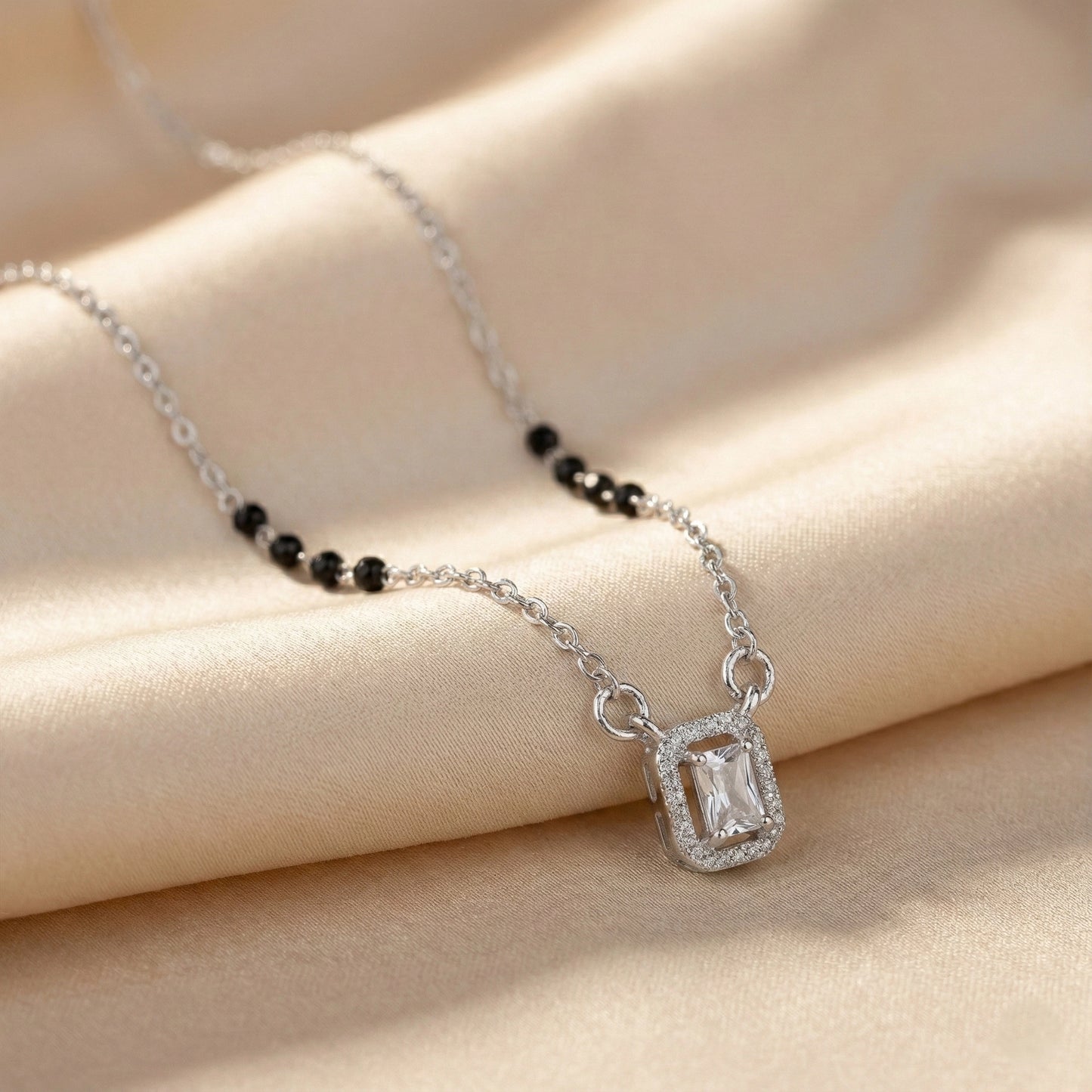 Silver mangalsutra with black beads and rectangular diamond halo pendant