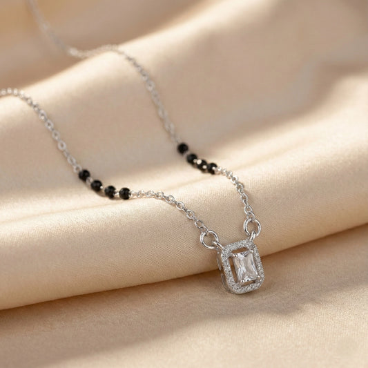 Silver mangalsutra with black beads and rectangular diamond halo pendant