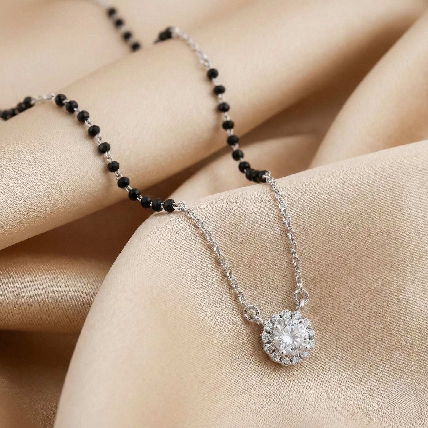 Silver mangalsutra with black beads and pear-shaped diamond halo pendant