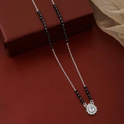 Necklace with a floral pendant on a red surface