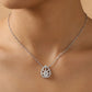 Teardrop-shaped diamond necklace on a person's neck