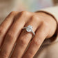 Diamond ring on a person's finger with a blurred background