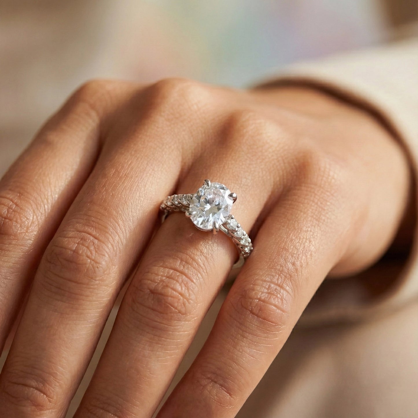 Diamond ring on a person's finger with a blurred background