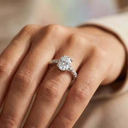 Diamond ring on a person's finger with a blurred background