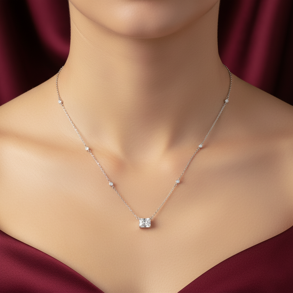 Necklace with a diamond pendant on a mannequin against a red curtain background