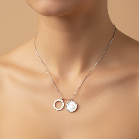 Necklace with two pendants on a mannequin against a beige background