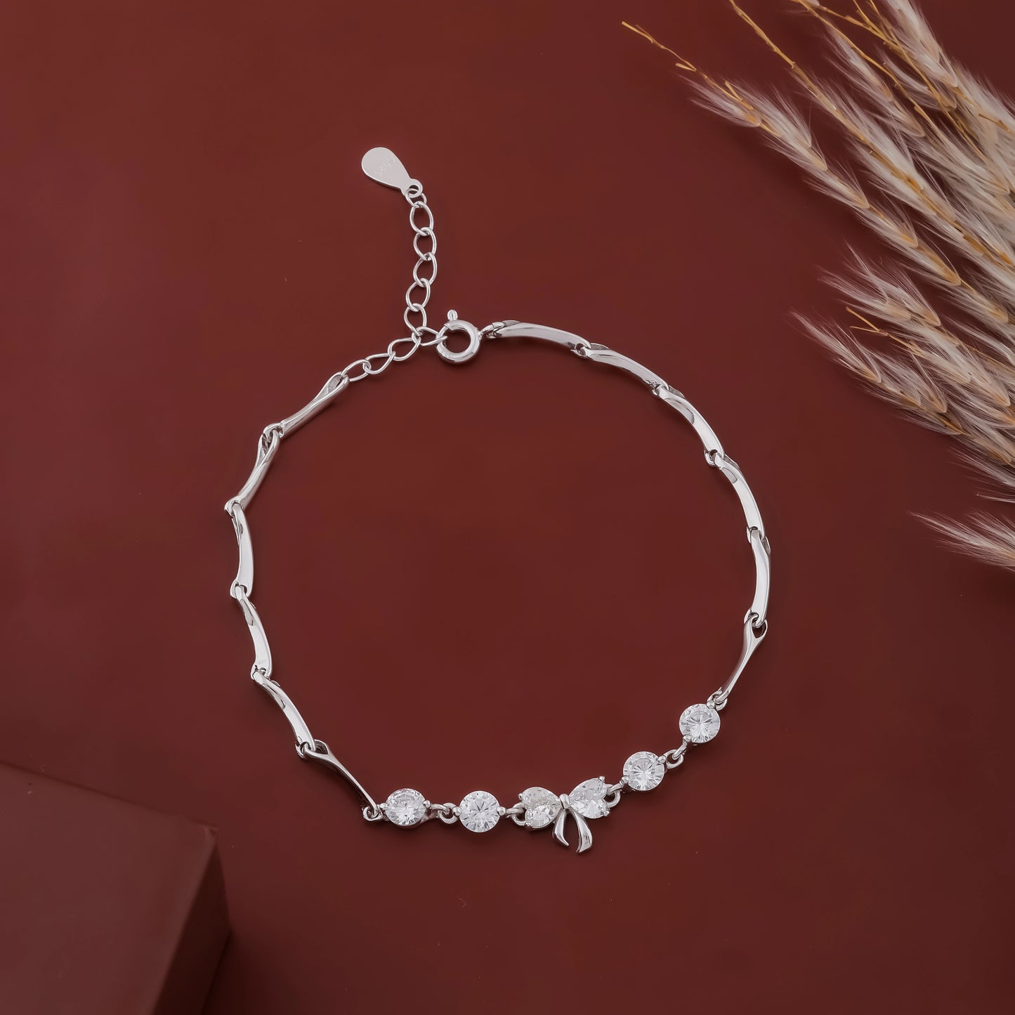 Silver bracelet with decorative elements on a brown background