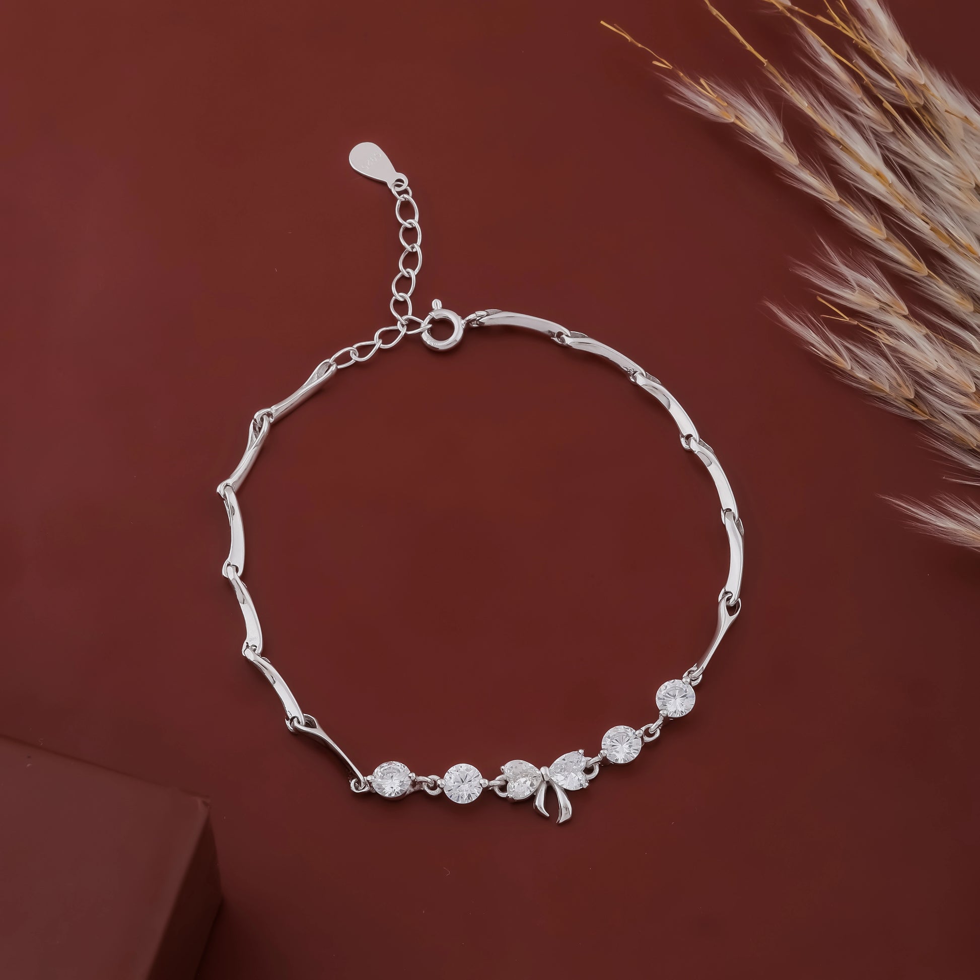 Silver bracelet with decorative elements on a brown background