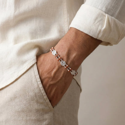 Close-up of a wrist wearing a bracelet with a neutral background