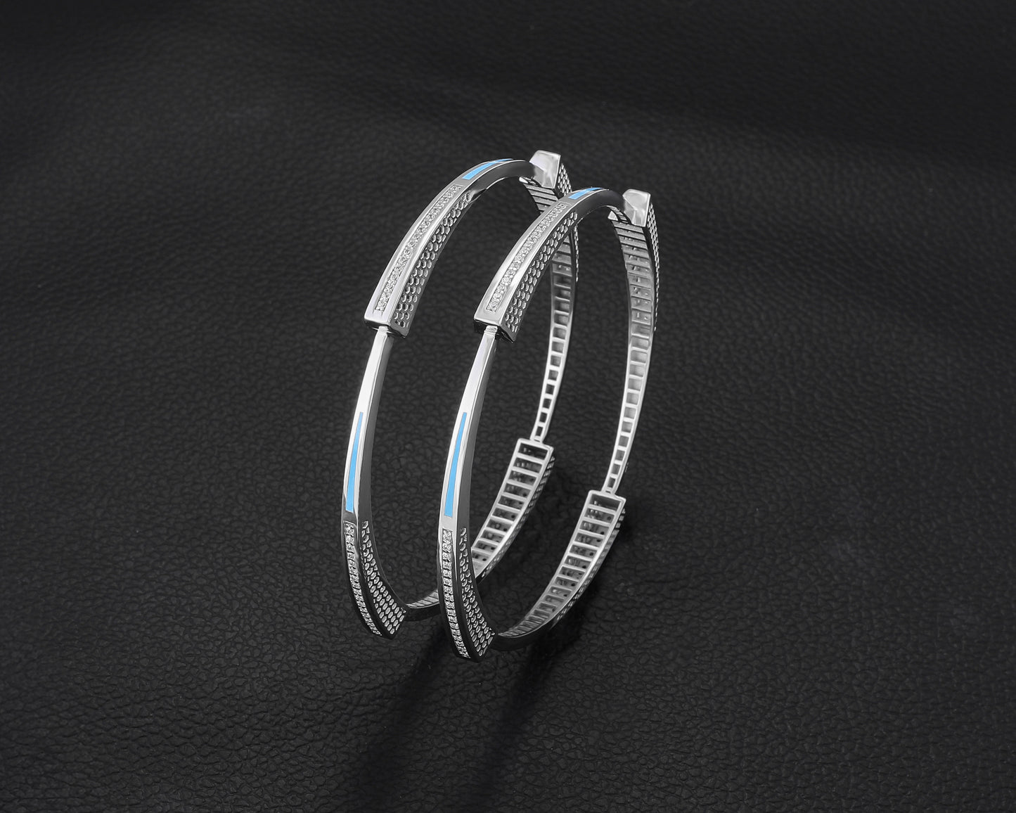 Pair of silver hoop earrings on a dark background