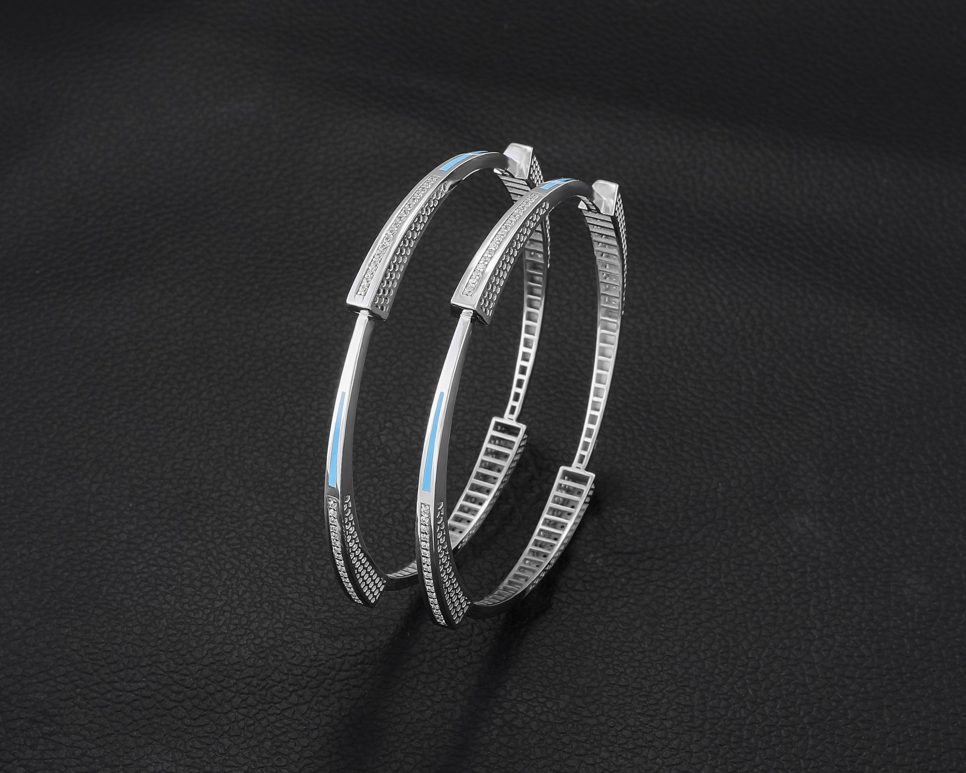Pair of silver hoop earrings on a dark background