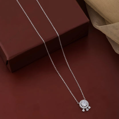 Silver necklace with a pendant on a dark brown surface