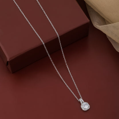 Silver necklace with a pendant on a brown surface