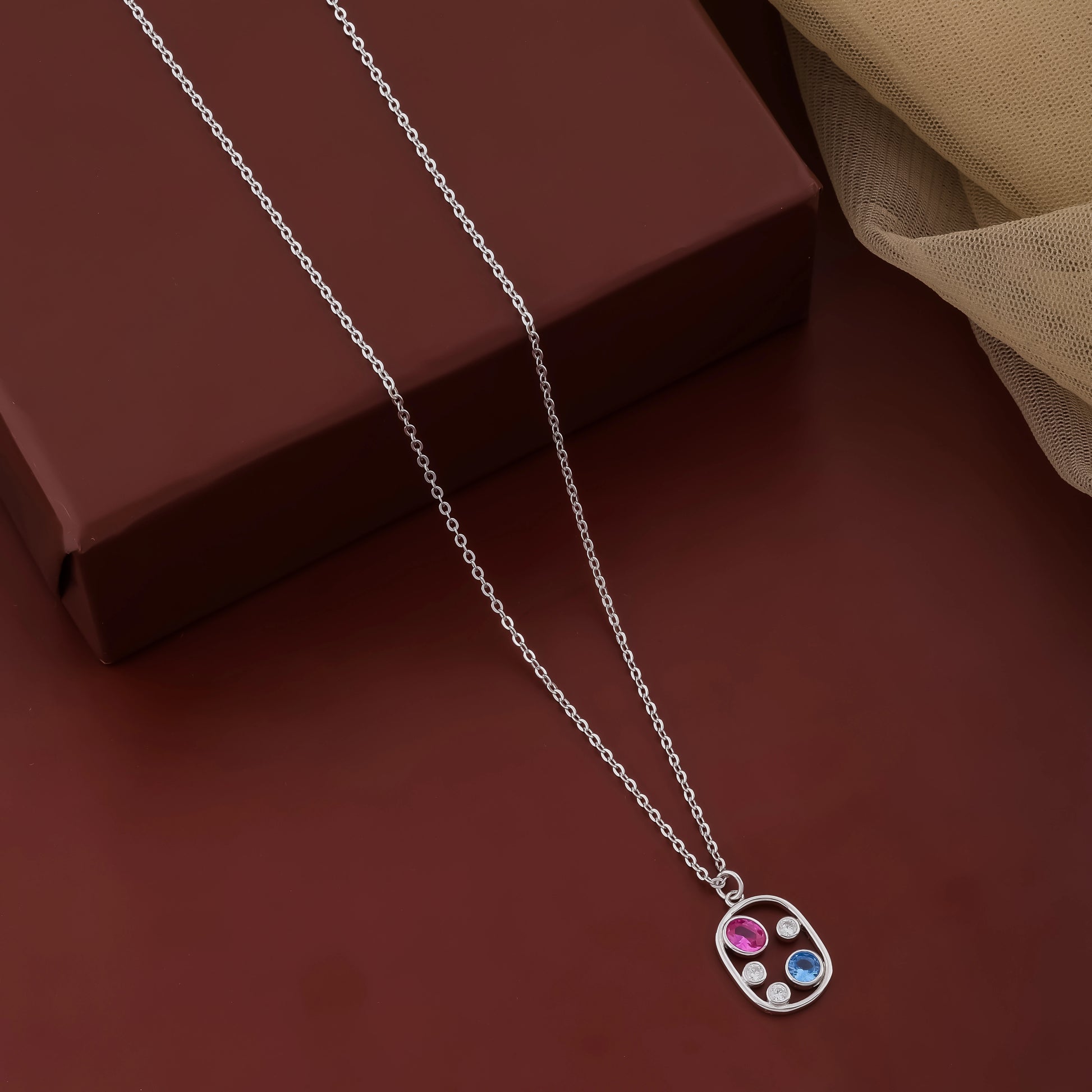 Necklace with a colorful pendant on a brown surface