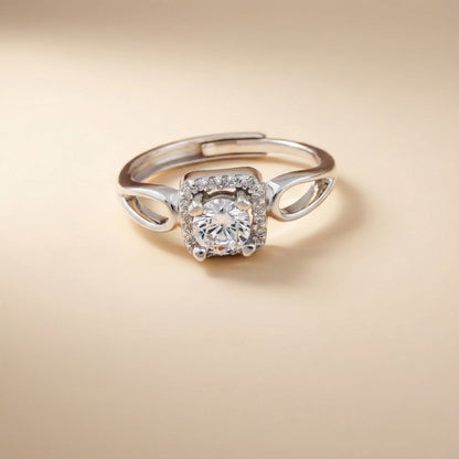 Silver ring with a diamond on a beige background