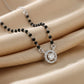 Silver mangalsutra with black beads and round diamond halo pendant