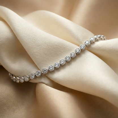 Silver bracelet with clear stones on beige fabric