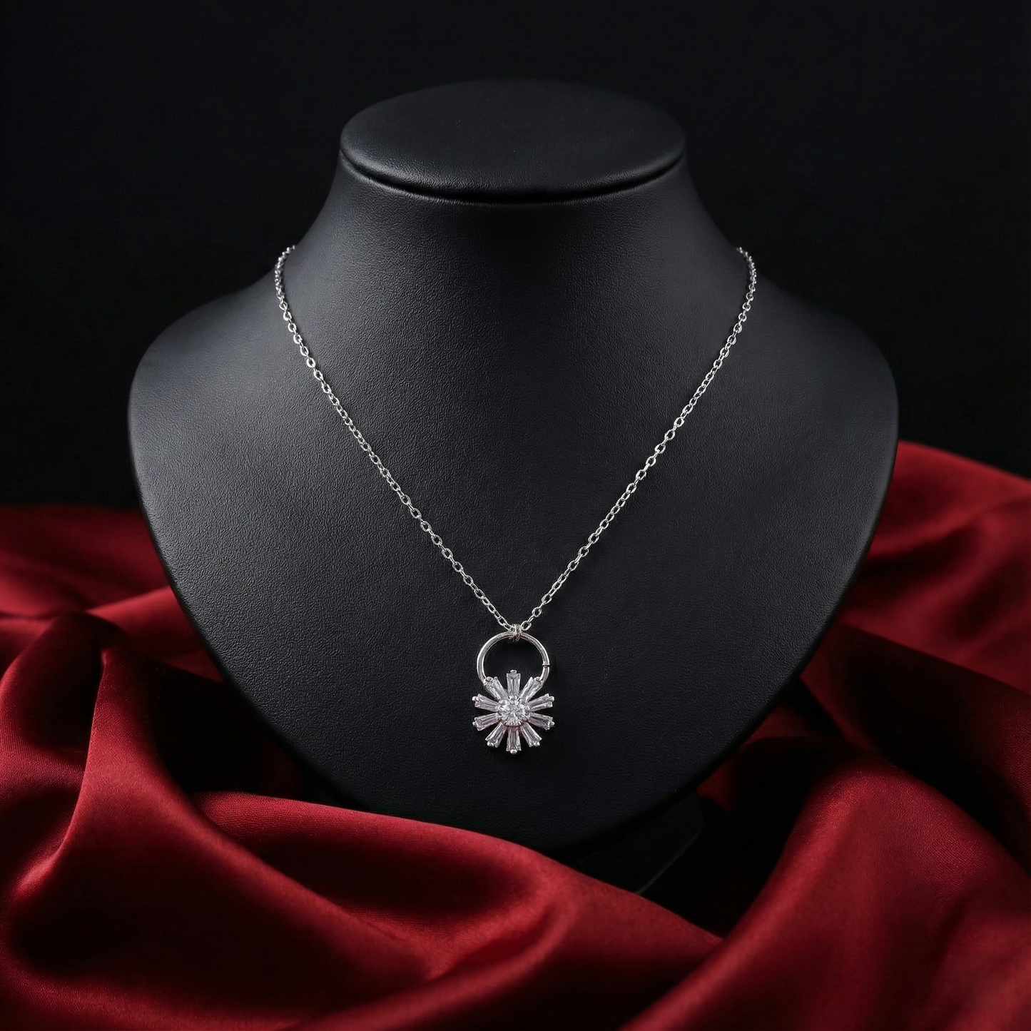 Silver necklace with a star-shaped pendant on a black mannequin bust against a dark background.