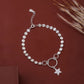 Silver bracelet with a star charm on a brown background