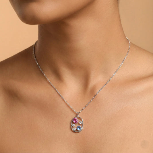 Necklace with a colorful pendant on a model against a beige background