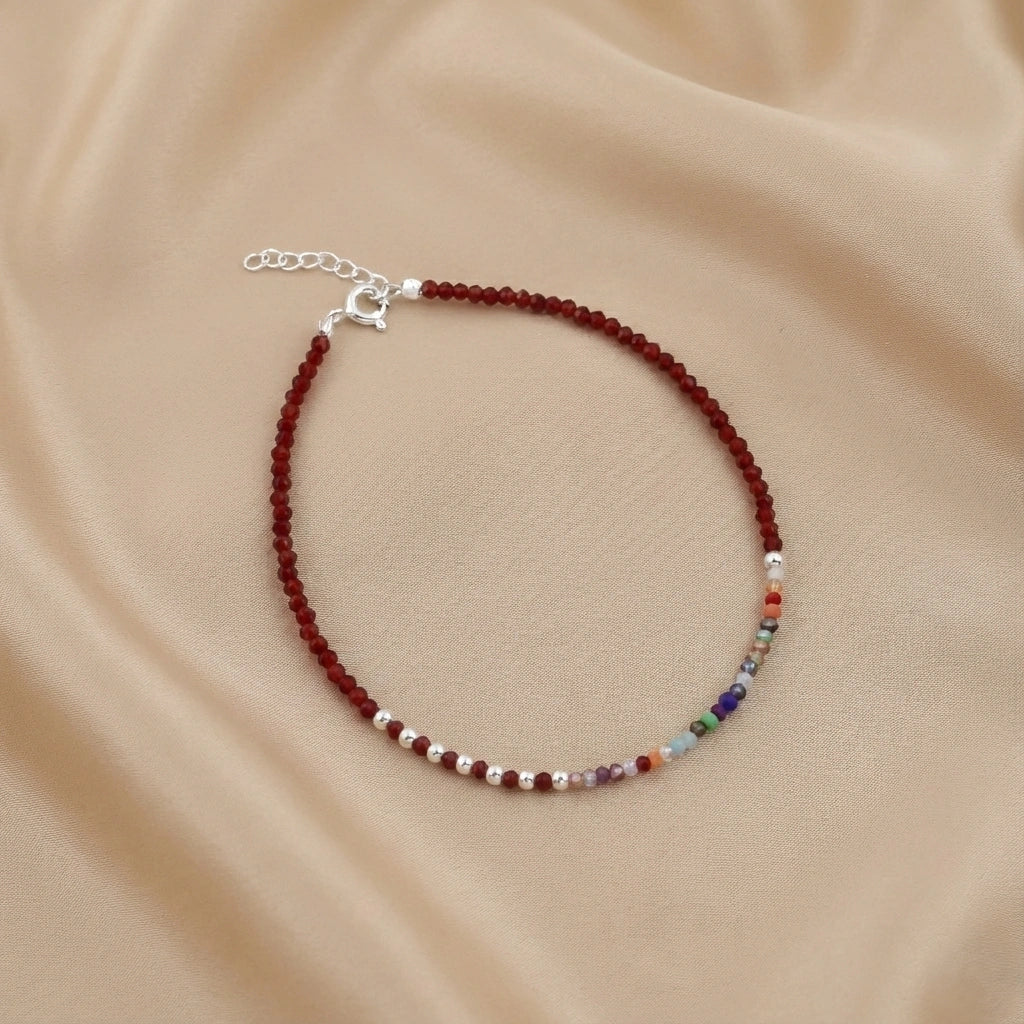 Beaded bracelet with multicolor beads on a beige fabric background