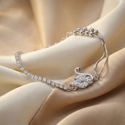 Silver bracelet with a pear-shaped diamond on a beige fabric background