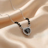 Silver mangalsutra with black beads and teardrop-shaped black stone halo pendant