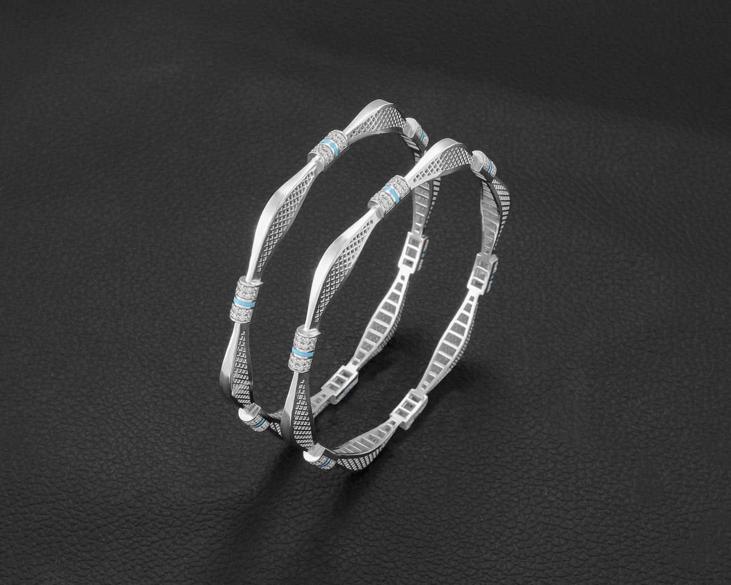 Two silver hoop earrings with turquoise stones on a dark background