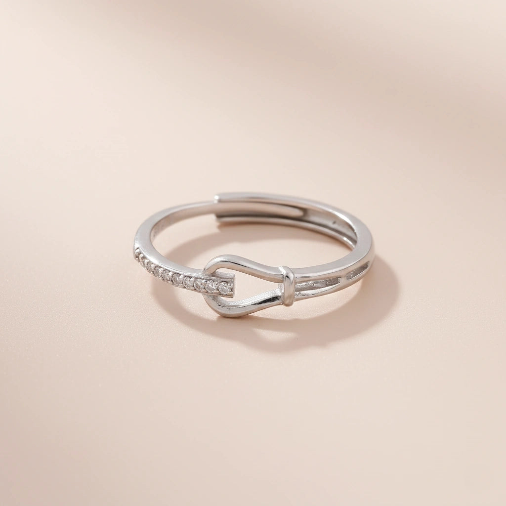Silver ring with a unique design on a beige background