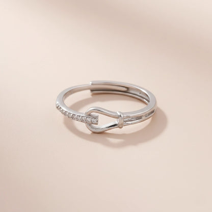 Silver ring with a unique design on a beige background