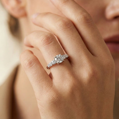 Close-up of a hand wearing a diamond ring with a blurred background