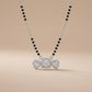 Necklace with heart-shaped pendants on a beige background