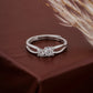 Silver ring with two diamonds on a brown fabric background