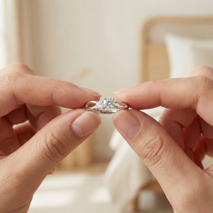 Close-up of hands holding a diamond ring against a blurred background