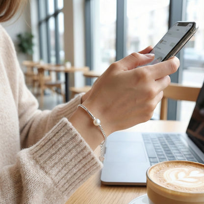 Person using a smartphone with a blurred background of a cafe setting