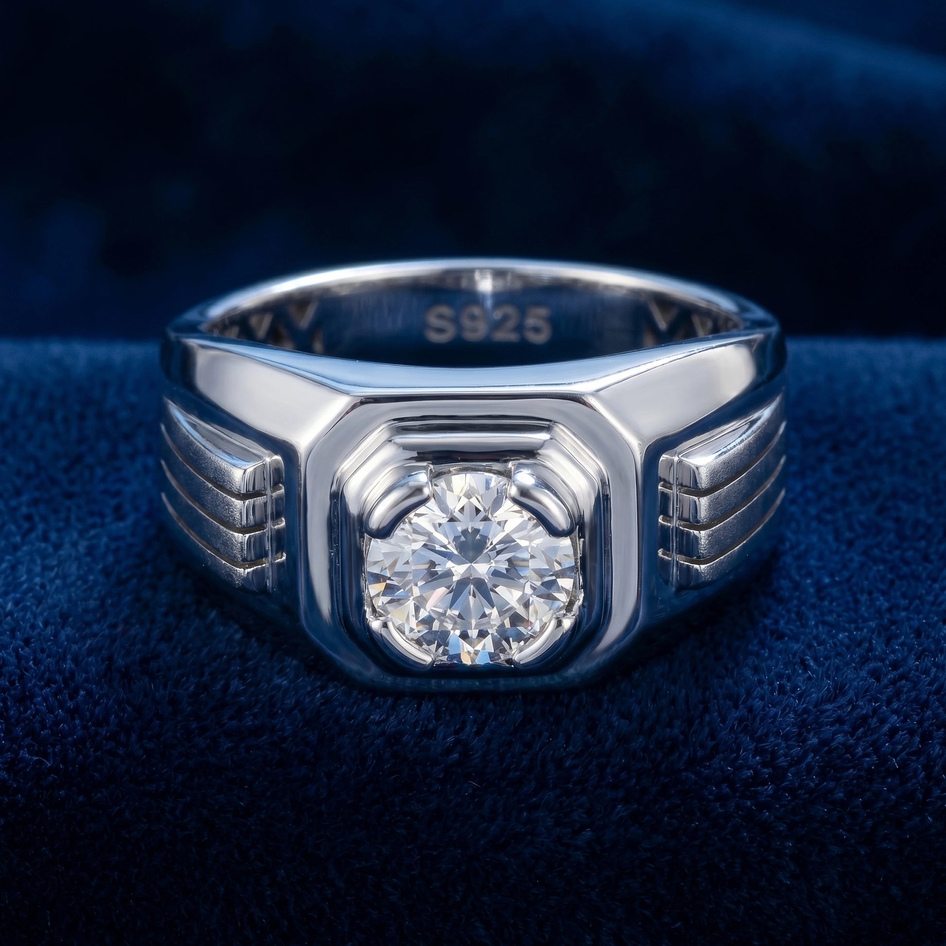 Silver ring with a diamond on a blue fabric background