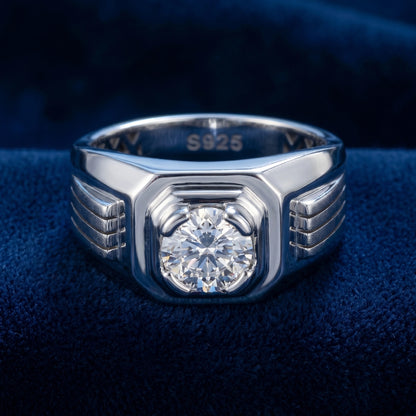 Silver ring with a diamond on a blue fabric background