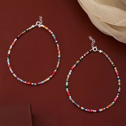 Two colorful beaded necklaces on a red background