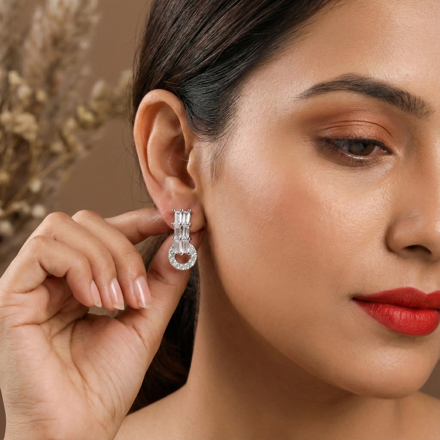 Close-up of a woman wearing a silver earring with a blurred background