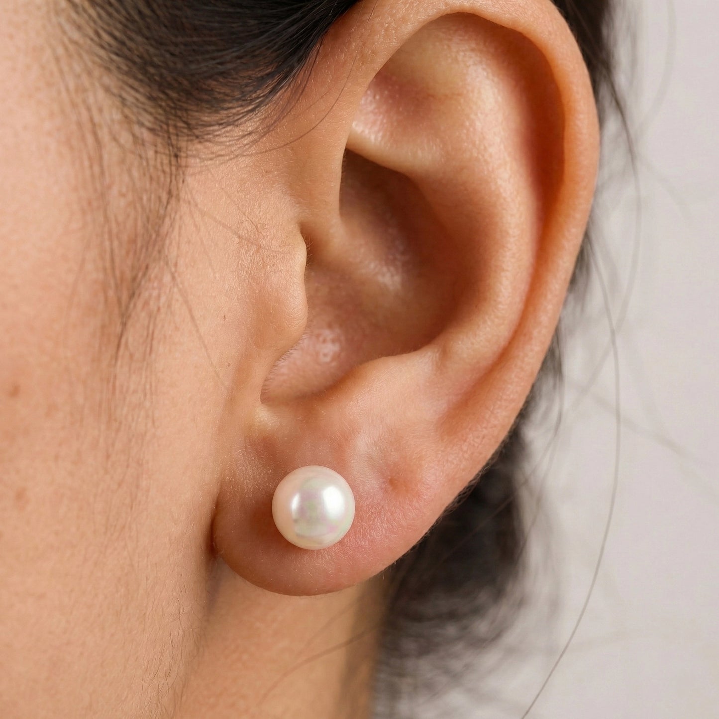 Pearl earrings on a marble surface