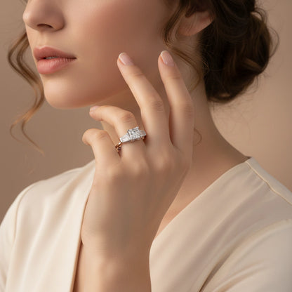 Close-up of a woman wearing a diamond ring on a neutral background