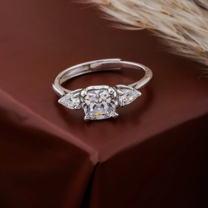 Silver ring with a diamond on a brown fabric background