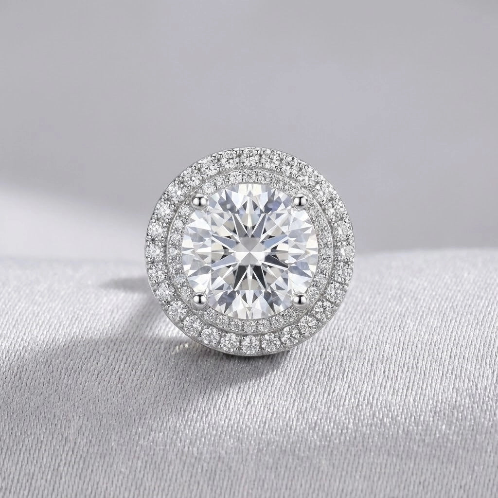 Silver earring with a large central gemstone on a gray background