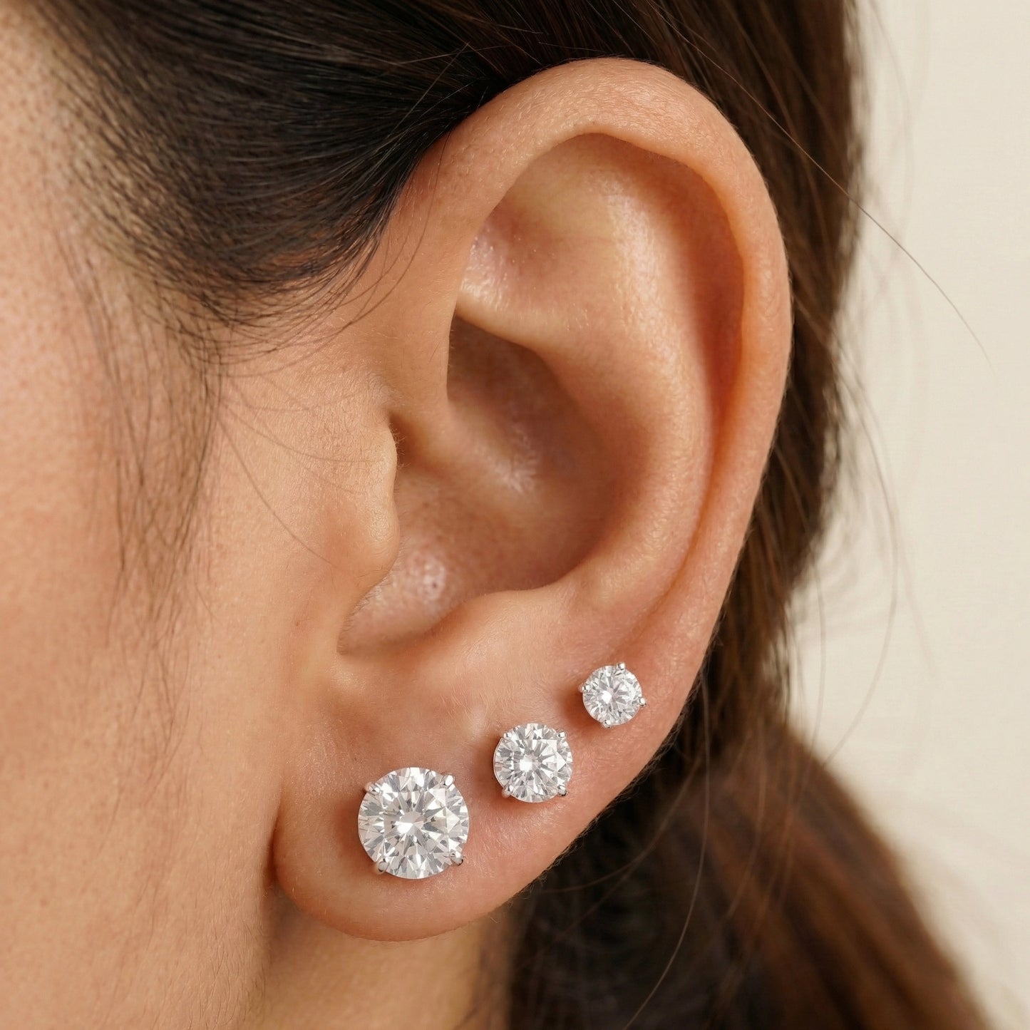 Set of round cubic zirconia stud earrings in 925 sterling silver showing multiple size options