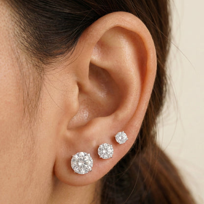 Set of round cubic zirconia stud earrings in 925 sterling silver showing multiple size options